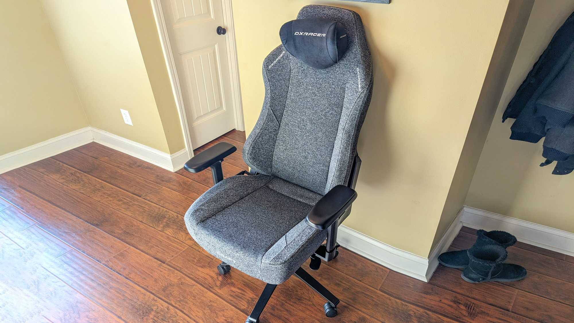 The fabric version of the DXRacer Craft up against a wall