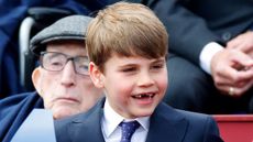 Prince Louis smiles as he attends a military procession, down The Mall, to mark the 80th anniversary of VE Day 