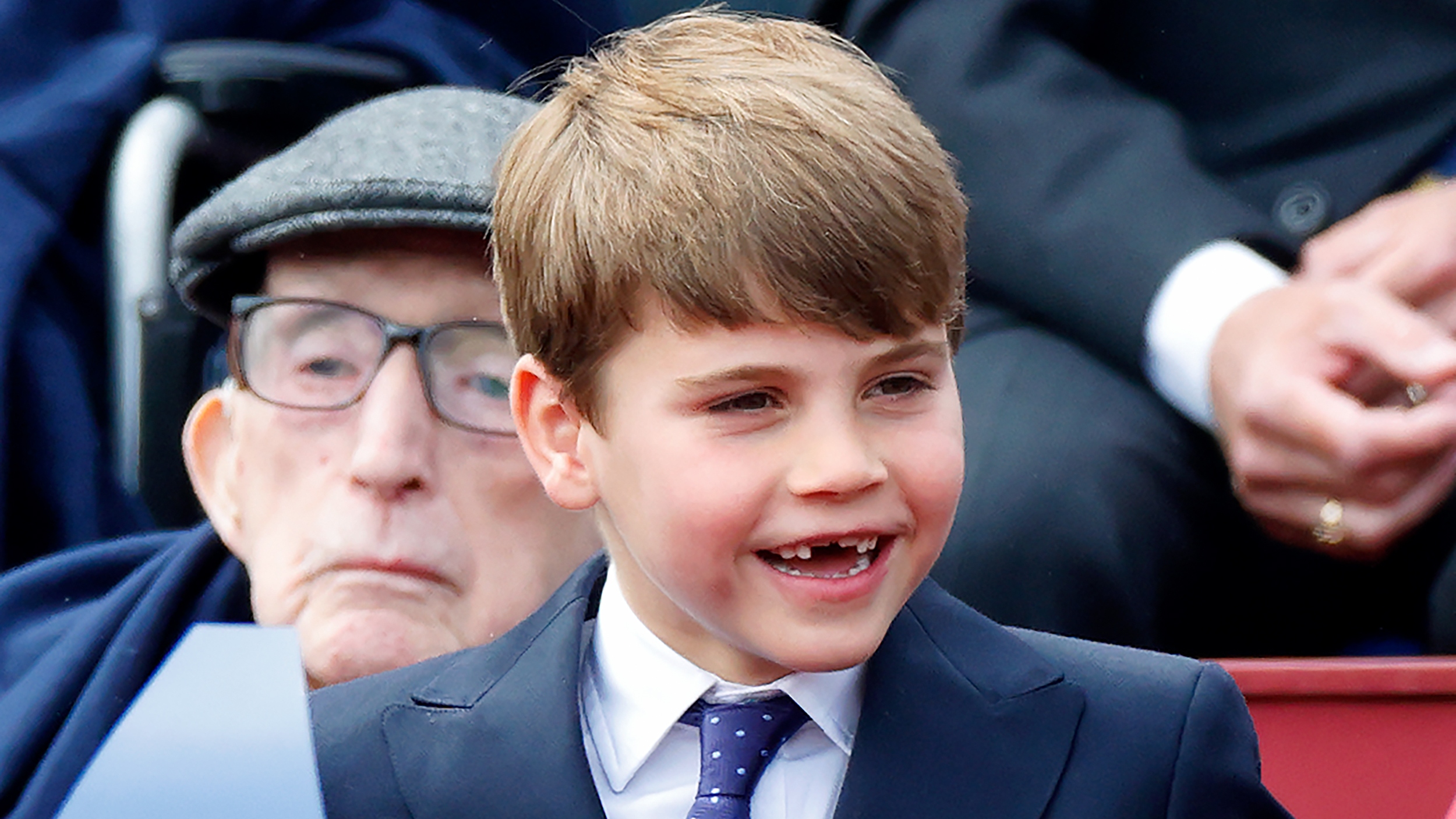 Prince Louis smiles as he attends a military procession, down The Mall, to mark the 80th anniversary of VE Day 