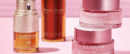 Clarins beauty products on pink background