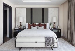 Large headboard with white outer panels with blue abstract face doodles, and grey innwer panel with two black vertical dividers