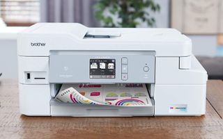 Brother INKvestment MFC-J995DW printer on a table