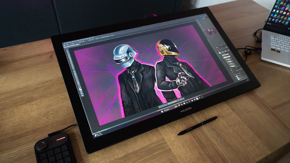 A Huion Kamvas Pro 27 drawing tablet in use on a desk