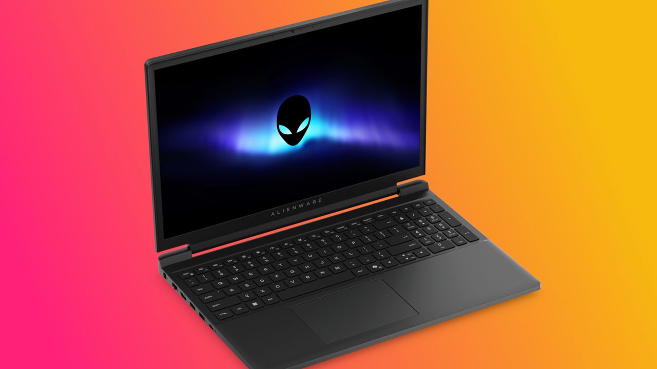 A sleek Alienware laptop is open against a vibrant orange-to-pink gradient background. The screen displays a glowing alien logo, creating a futuristic feel.