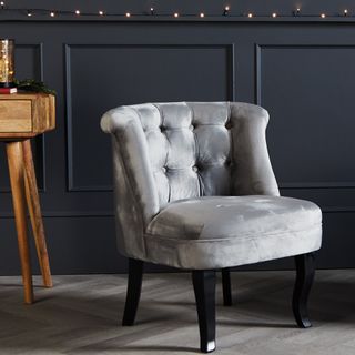 grey velvet armchair in blue room