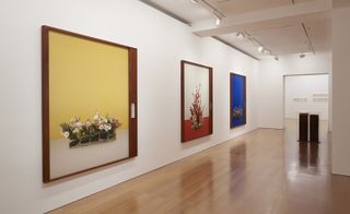 Installation view of floral portraits on display.