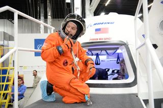 NASA astronaut Randy Bresnik prepares to enter the CST-100 spacecraft, which was built inside The Boeing Company's Houston Product Support Center. Image released July 22, 2013.