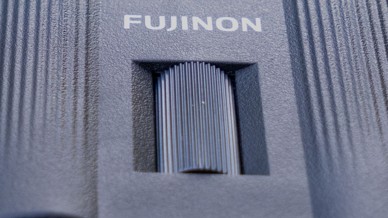 A close-up of the focusing wheel on the Fujifilm Techno-Stabi TS-L 1640 image-stabilized binoculars.