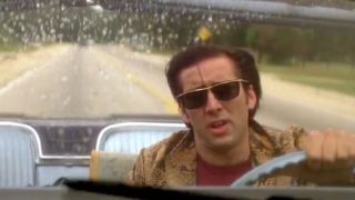 Nic Cage in his snake skin jacket, driving a convertible in Wild At Art.