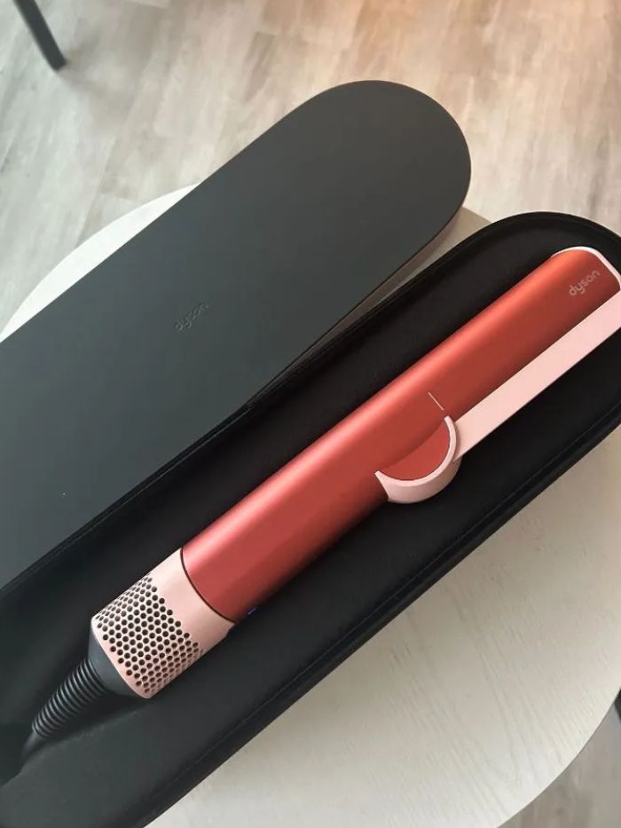 The Dyson Airstrait in its display case