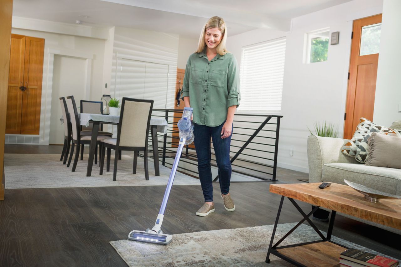 woman using a Tineco A11 Hero vacuum