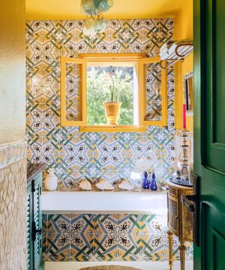 maximal bathroom with patterned tiles and yellow walls