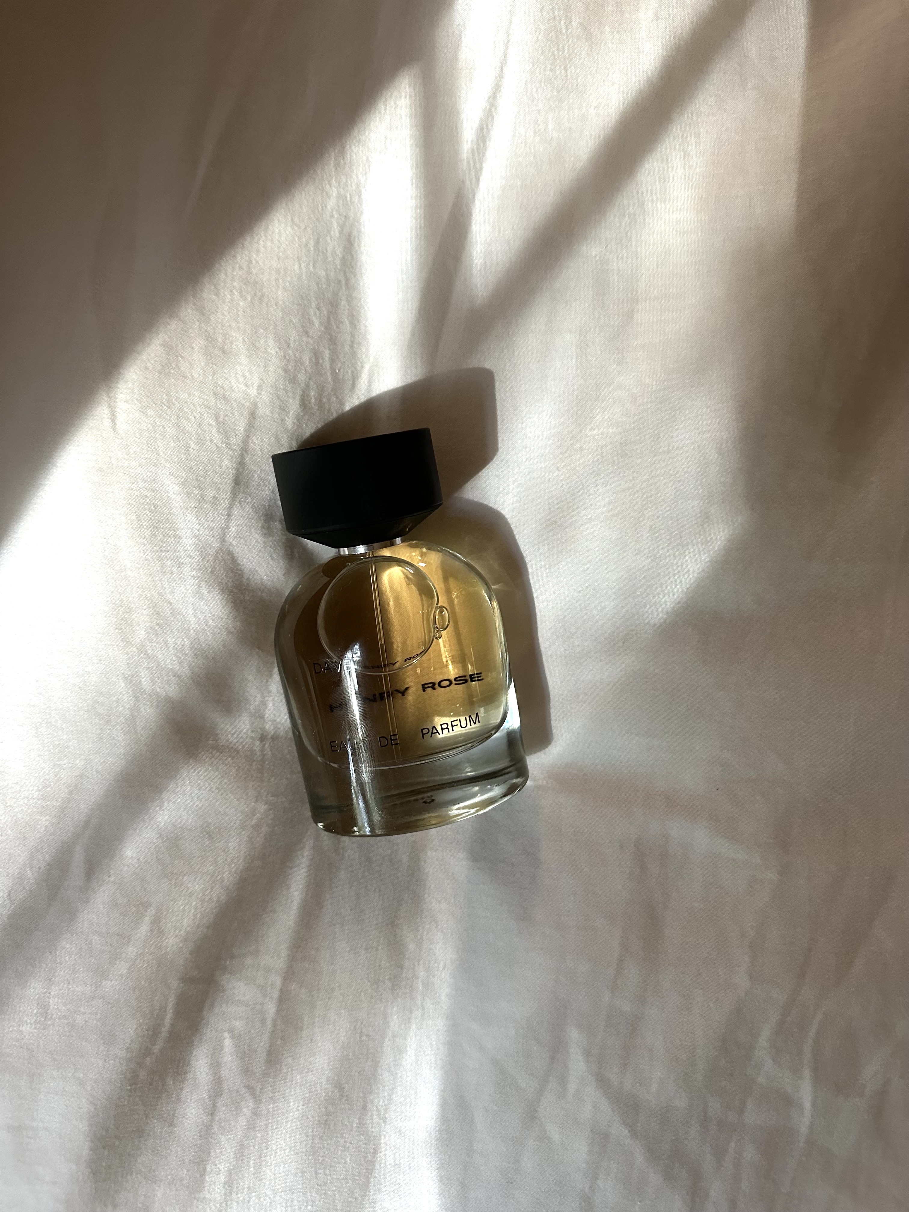 Photo of Kaitlyn McLintock testing Henry Rose Dave Eau de Parfum