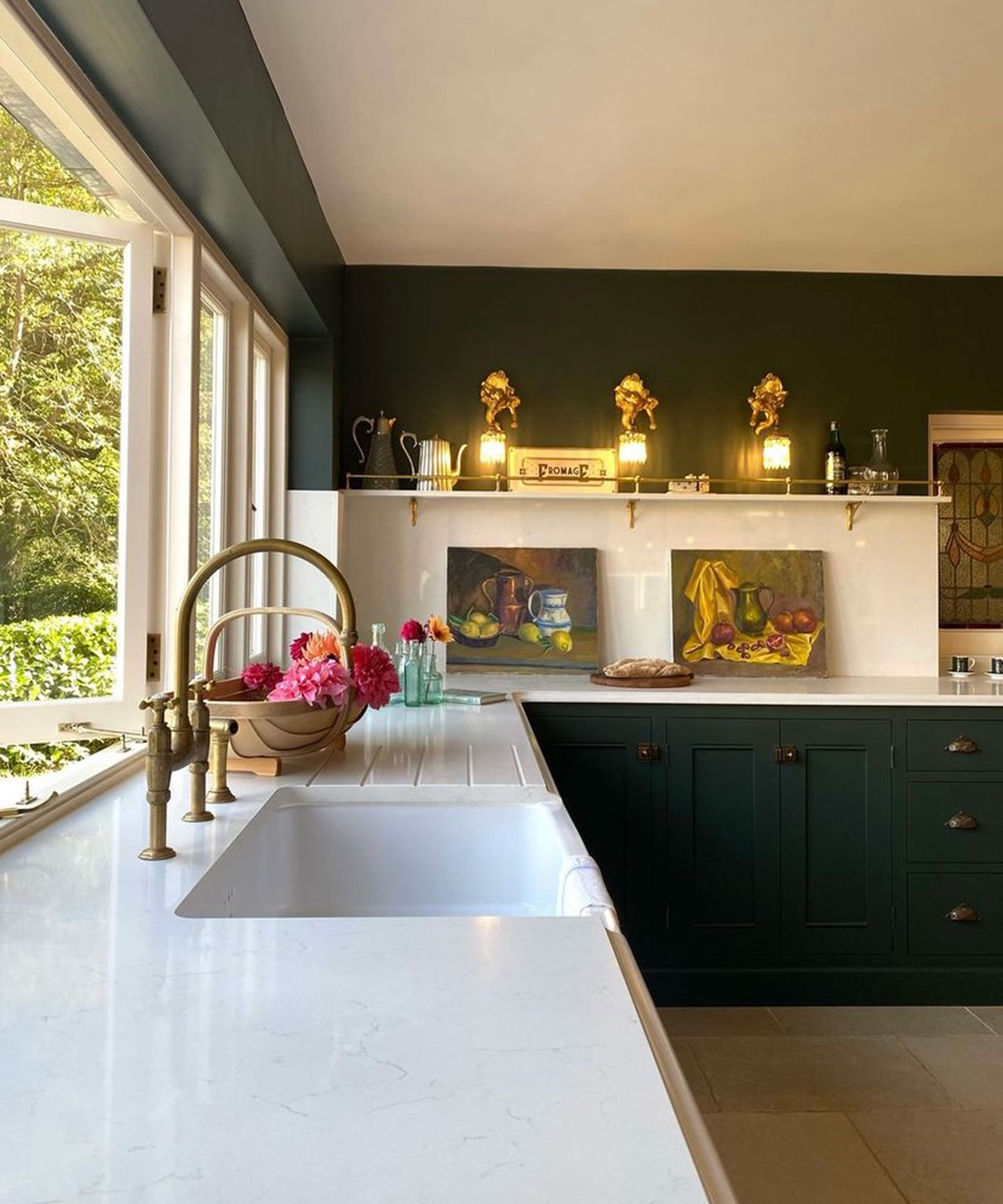 dark green kitchen white white worktops and brass kitchen tap