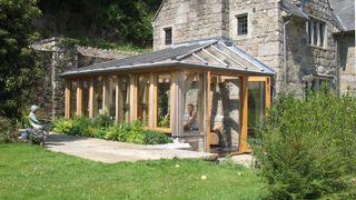 oak frame conservatory attached to side of traditional stone detached property