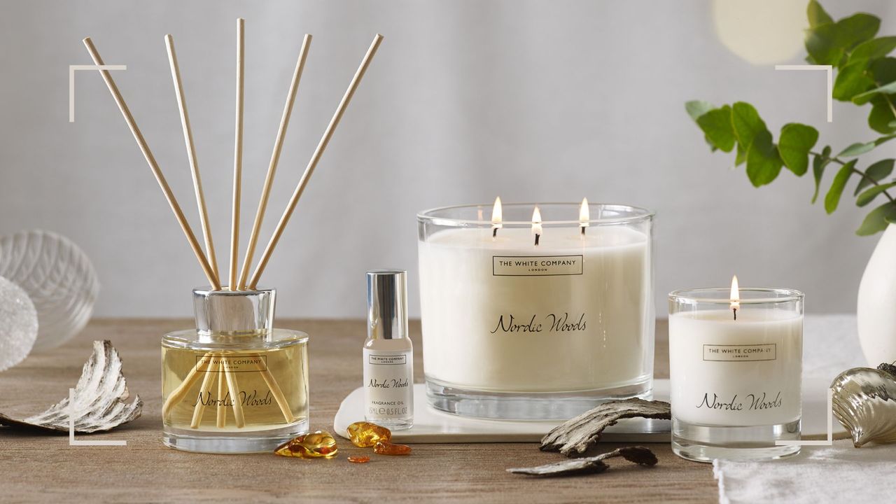 Lifestyle shot of new The White Company Nordic Woods signature scent candles and diffuser 