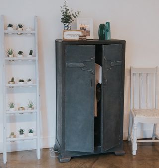 Lynne Lambourne's upcycling work on display: a ladder-turned-plant potter, a newly painted cabinet and a chair seat decoupaged with old maps of London.