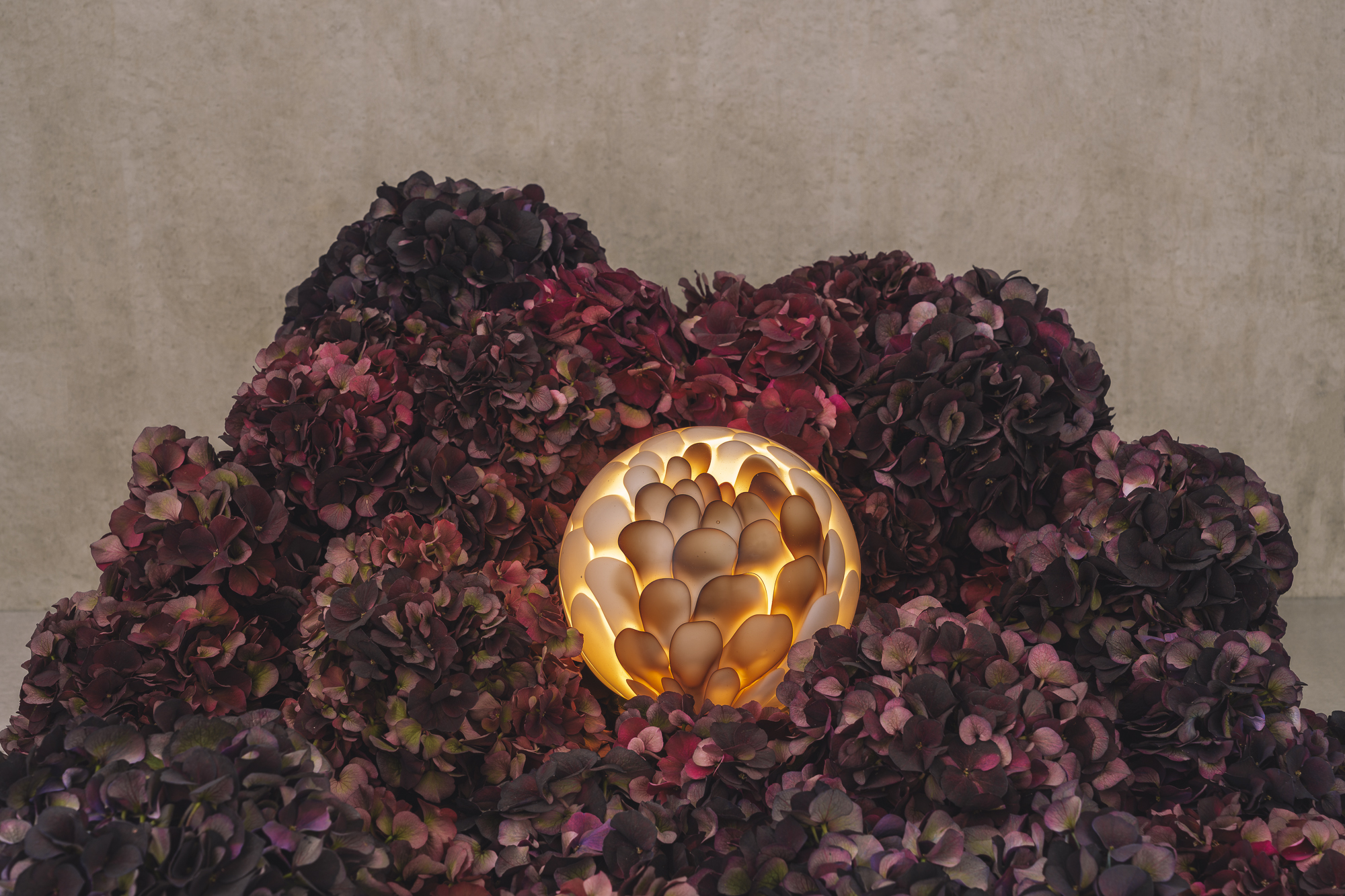 hand-formed glass lamps arranged in floral displays