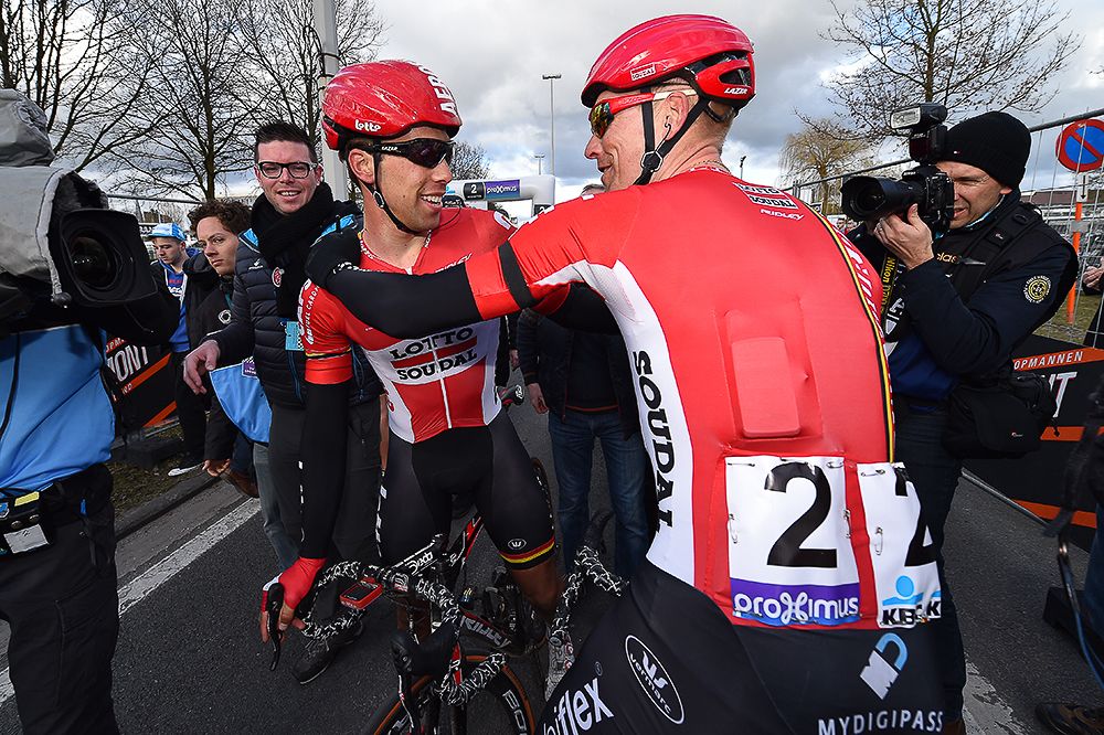 Jens Debusschere (Lotto Soudal) celebrates with a teammate after winning Dwars door Vlaanderen
