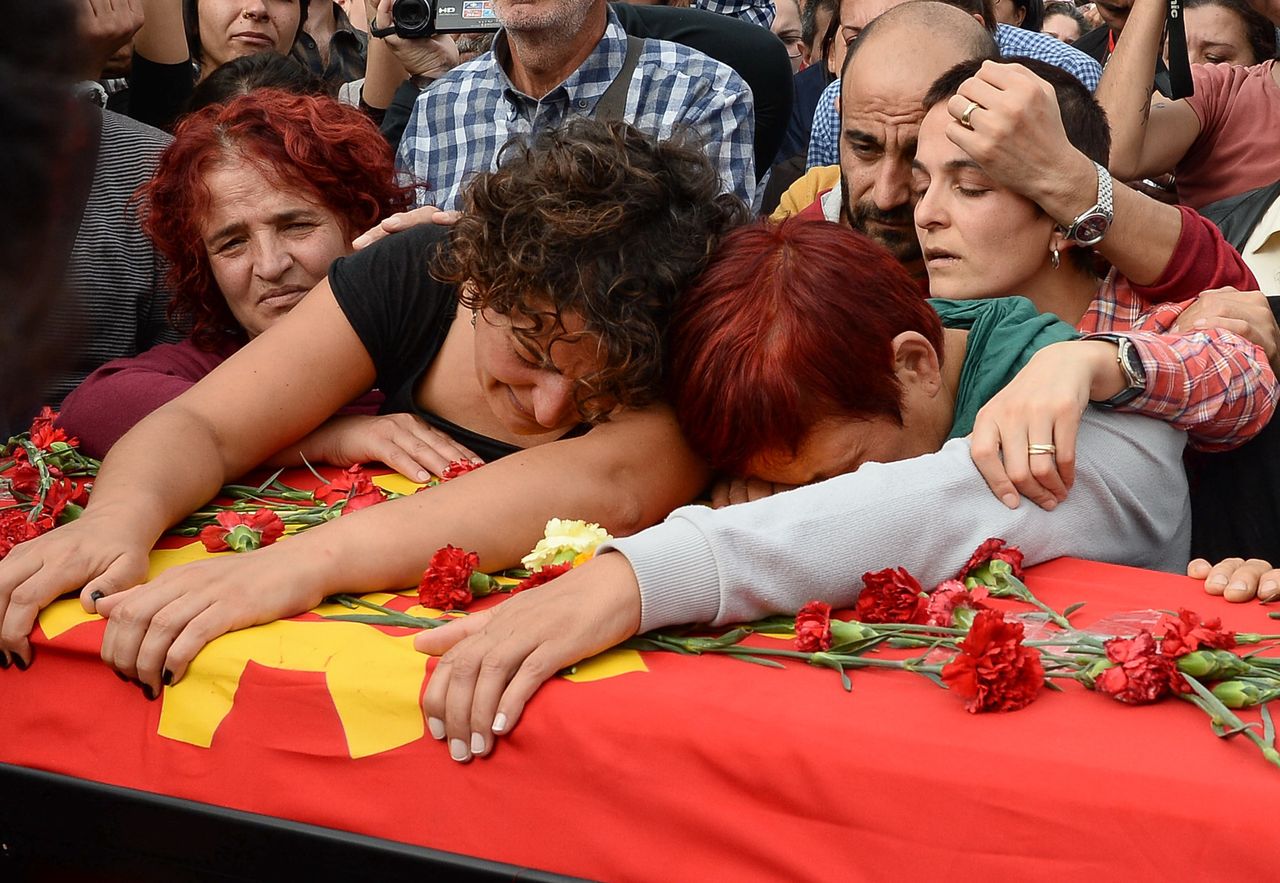 Family members of Korkmaz Tedik mourn over the coffin of the victim of suicide bomb blasts in Ankara, Turkey