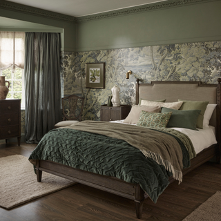 A green themed bedroom with green full length curtains and a green layered bed