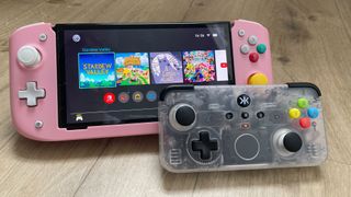 The CRKD Neo S placed on a wooden surface alongside a Nintendo Switch console.