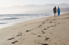 Couple walking together at beach, Santa Monica Beach, California