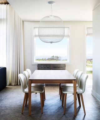White chairs, wooden legs and dining table, white lampshade