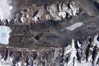 NASA Earth-Observing Satellite photo showing Don Juan Pond, a network of channels carved into the bedrock east of the Wright Upper Glacier, and the frozen Lake Vanda to the northeast of the pond.