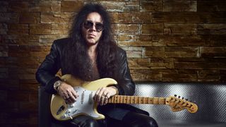 Yngwie Malsteen poses in London with his signature Fender Stratocaster.