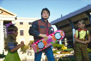 Screenshot from Back to the Future two showing Marty McFly holding a hoverboard.