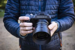 The Hasselblad X2D 100C camera in reviewer's hands