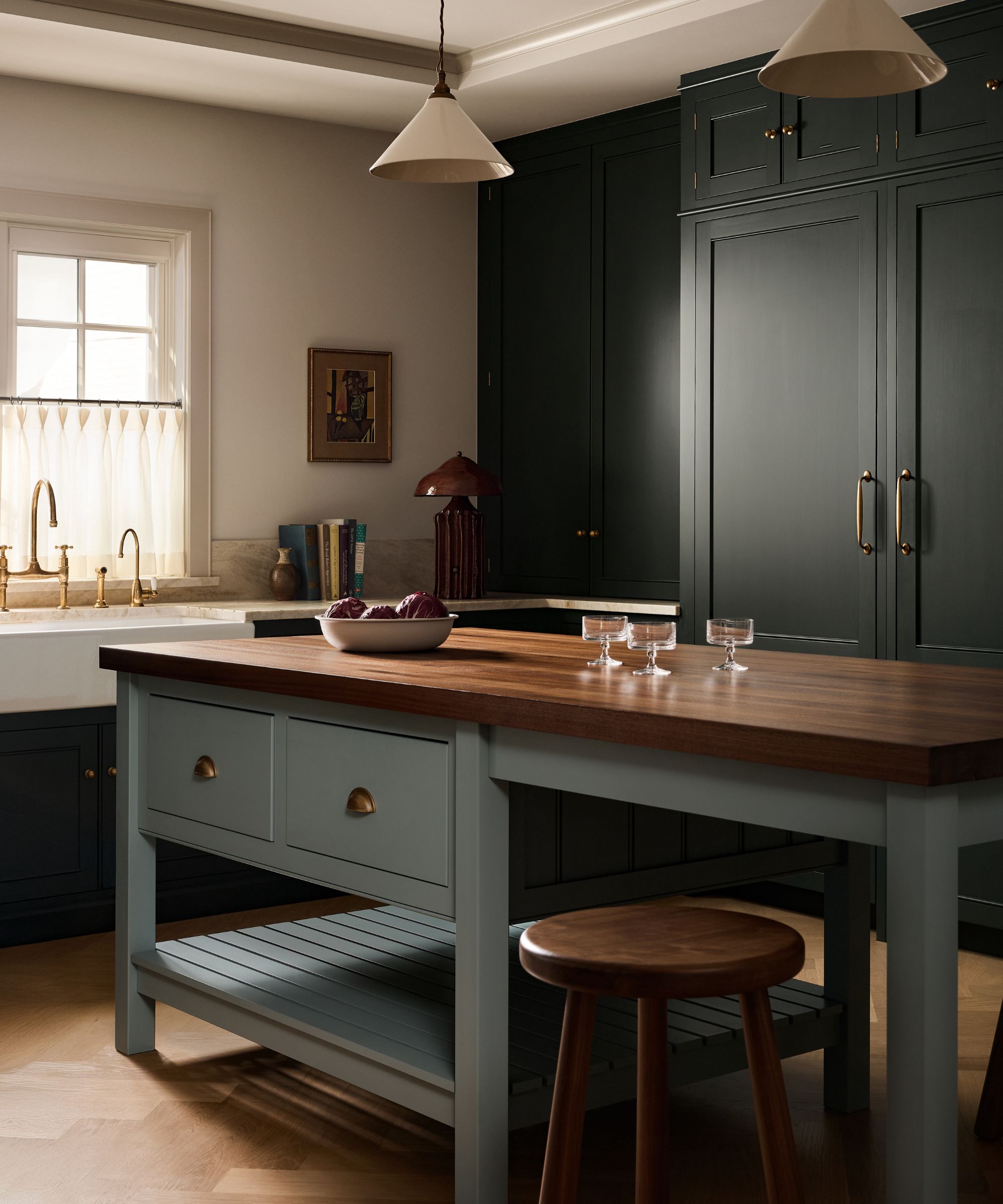 a deep blue deVOL kitchen by Yond Interiors with a mid blue island with dark wooden countertops