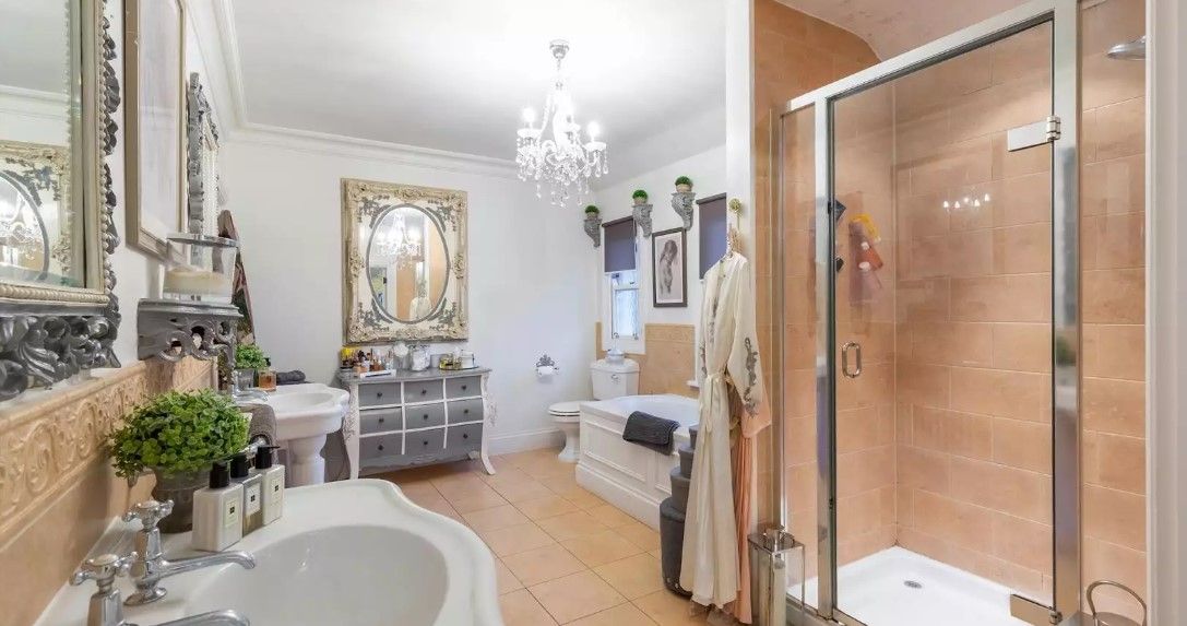 The bathroom has a walk in shower and tiled flooring