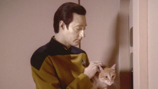 Brent Spiner's Data holding Spot the cat in Star Trek: The Next Generation