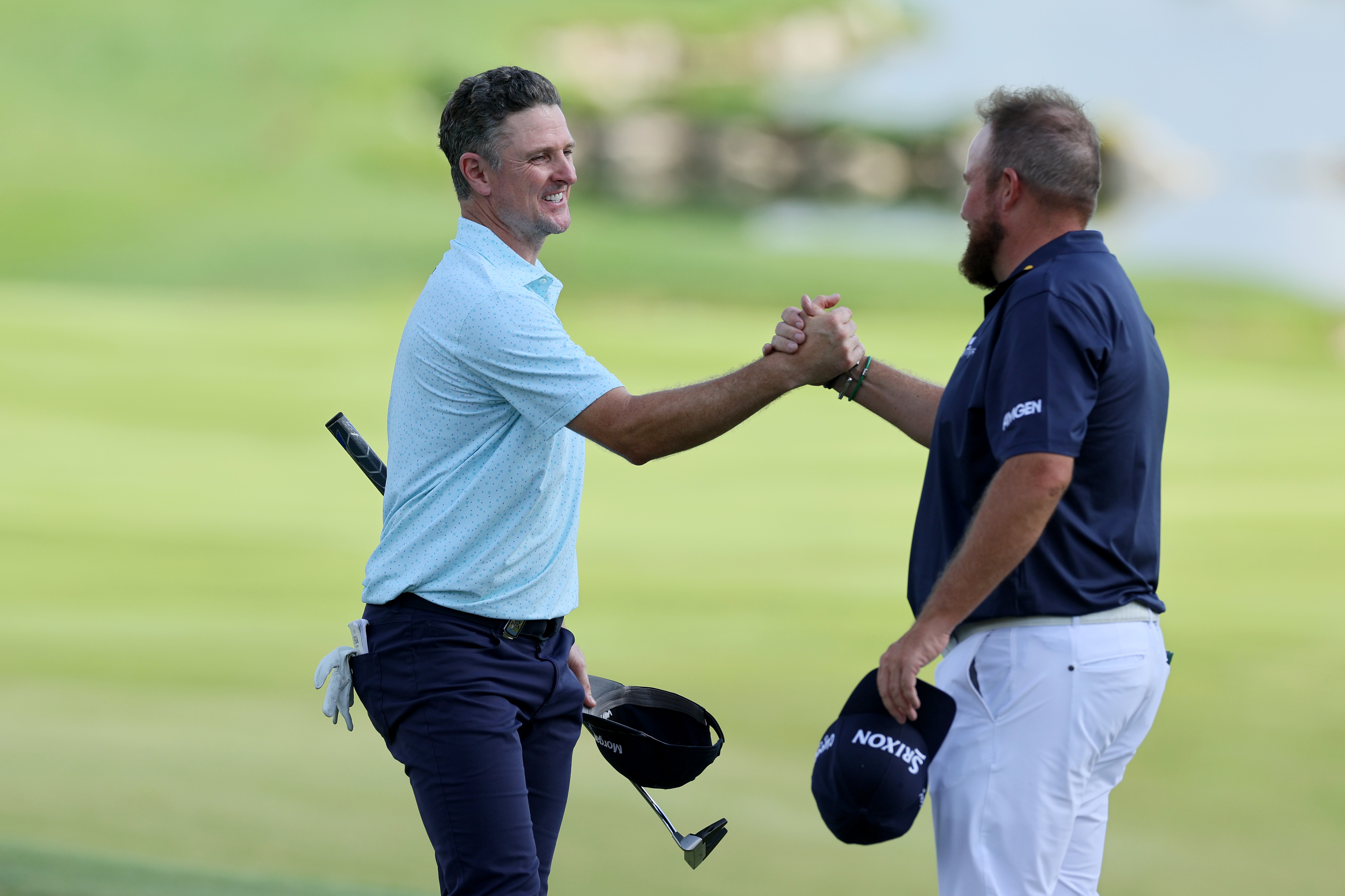 Shane Lowry and Justin Rose shake hands
