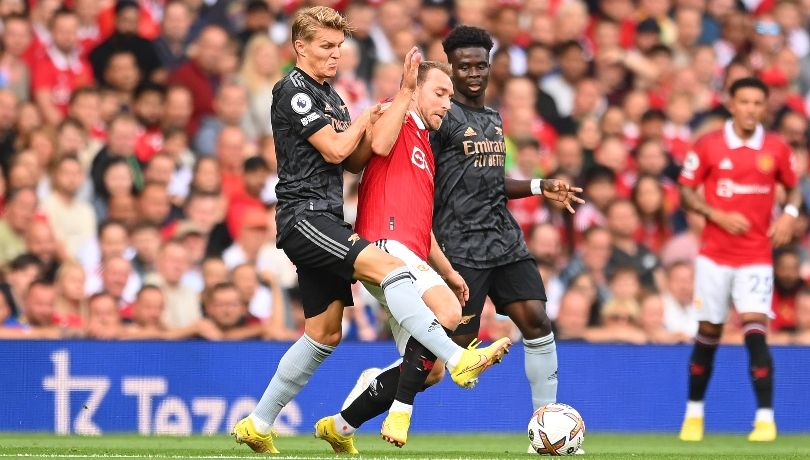 Martin Odegaard challenges Christian Eriksen in an action penalised by VAR as Arsenal see a goal ruled out against Manchester United.