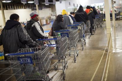Shoppers wait in line to shop for food at the St. Vincent de Paul food pantry in Indianapolis, Indiana.