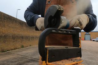 OnGuard RockSoild being subjected to an angle grinder attack with plombs of disc dust coming of the grinder