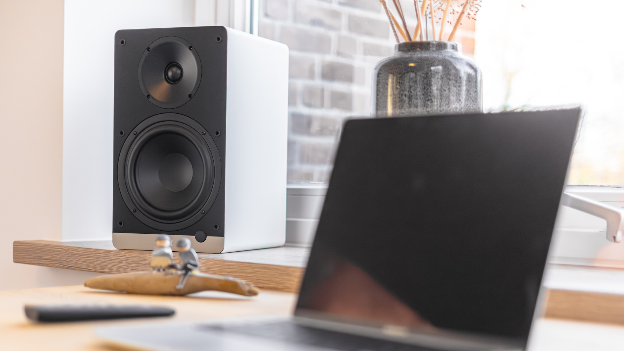 ELAC ConneX DCB61 on a window sill with a laptop in the foreground