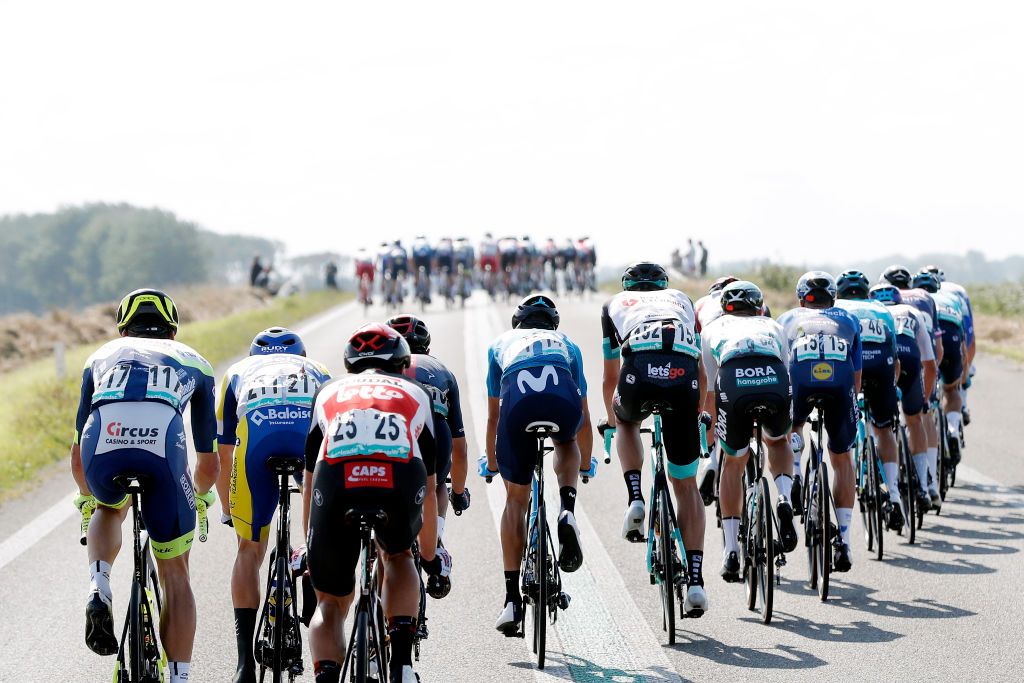 DOKKUM NETHERLANDS AUGUST 30 A general view of the peloton compete while echelons are created due crosswind during the 17th Benelux Tour 2021 Stage 1 a 1696km stage from Surhuisterveen to Dokkum BeneluxTour on August 30 2021 in Dokkum Netherlands Photo by Bas CzerwinskiGetty Images