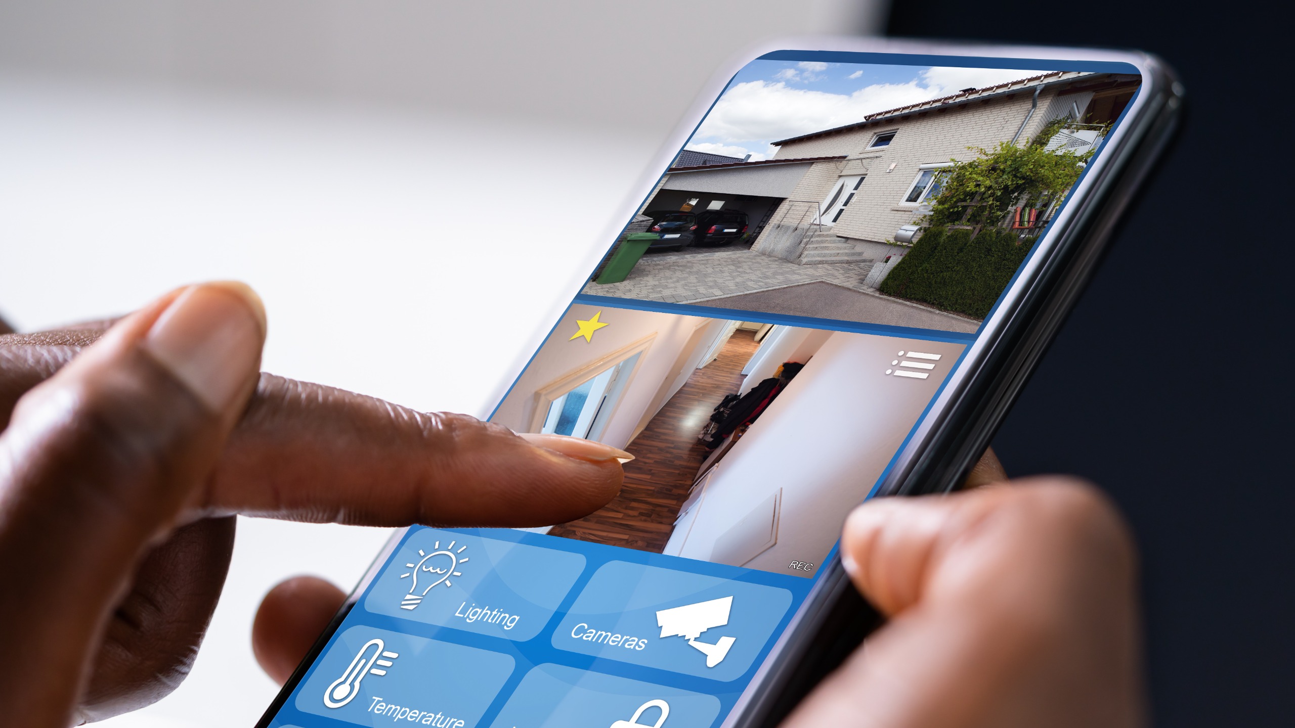 Person using home security app to view camera footage