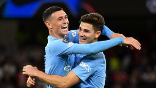 Julian Alvarez of Manchester City celebrates with teammate Phil Foden after scoring ahead of theteam's UEFA Champions League match