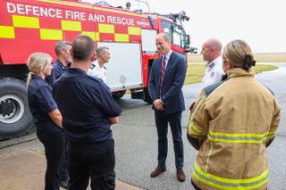 Britain's Prince William, Prince of Wales, speaks to base personnel after a simulated fire response exercise during a visit to RAF Valley in Holyhead in Anglesey, North Wales, on July 9, 2024