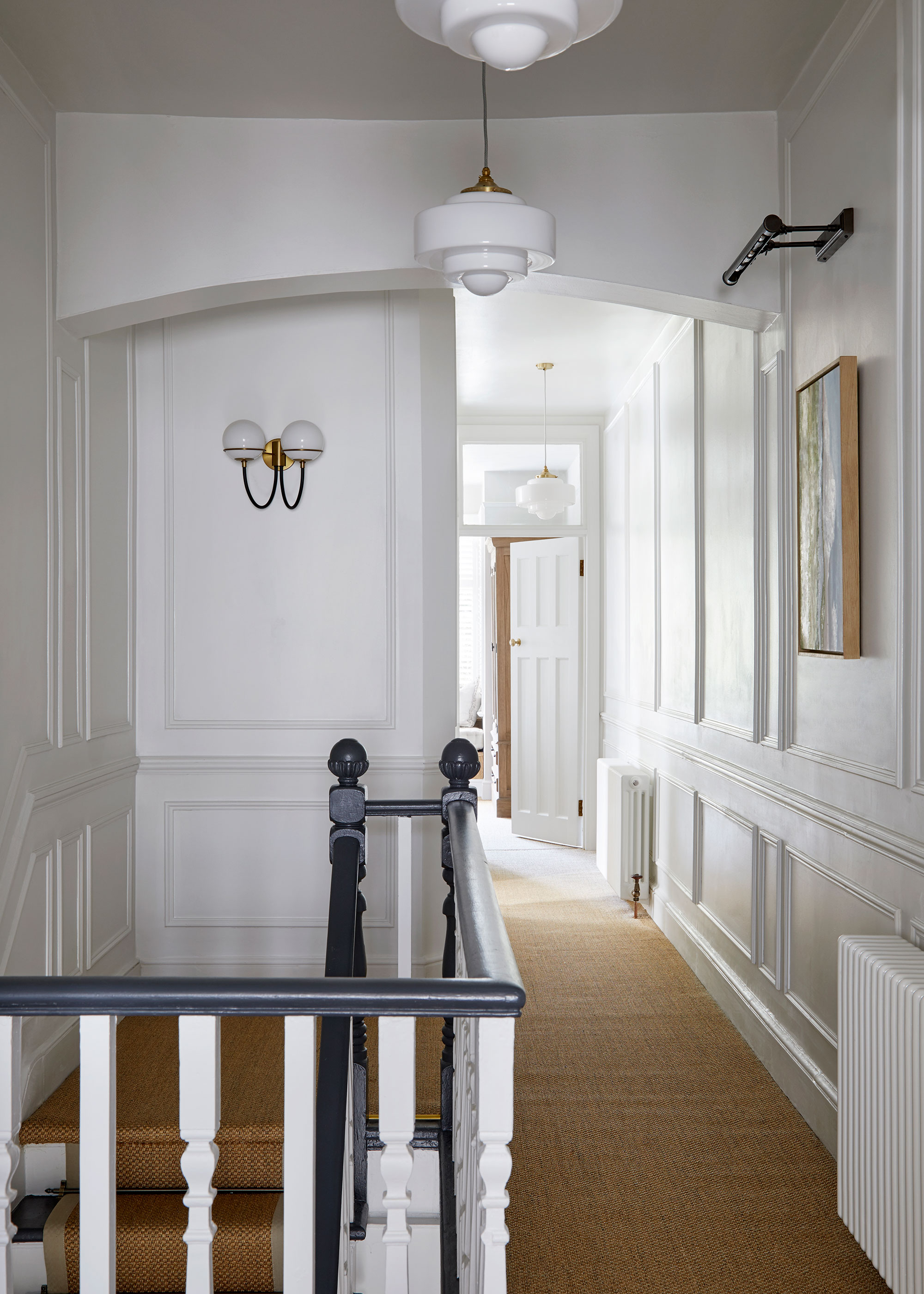 landing in period townhouse with natural flooring and column radiators