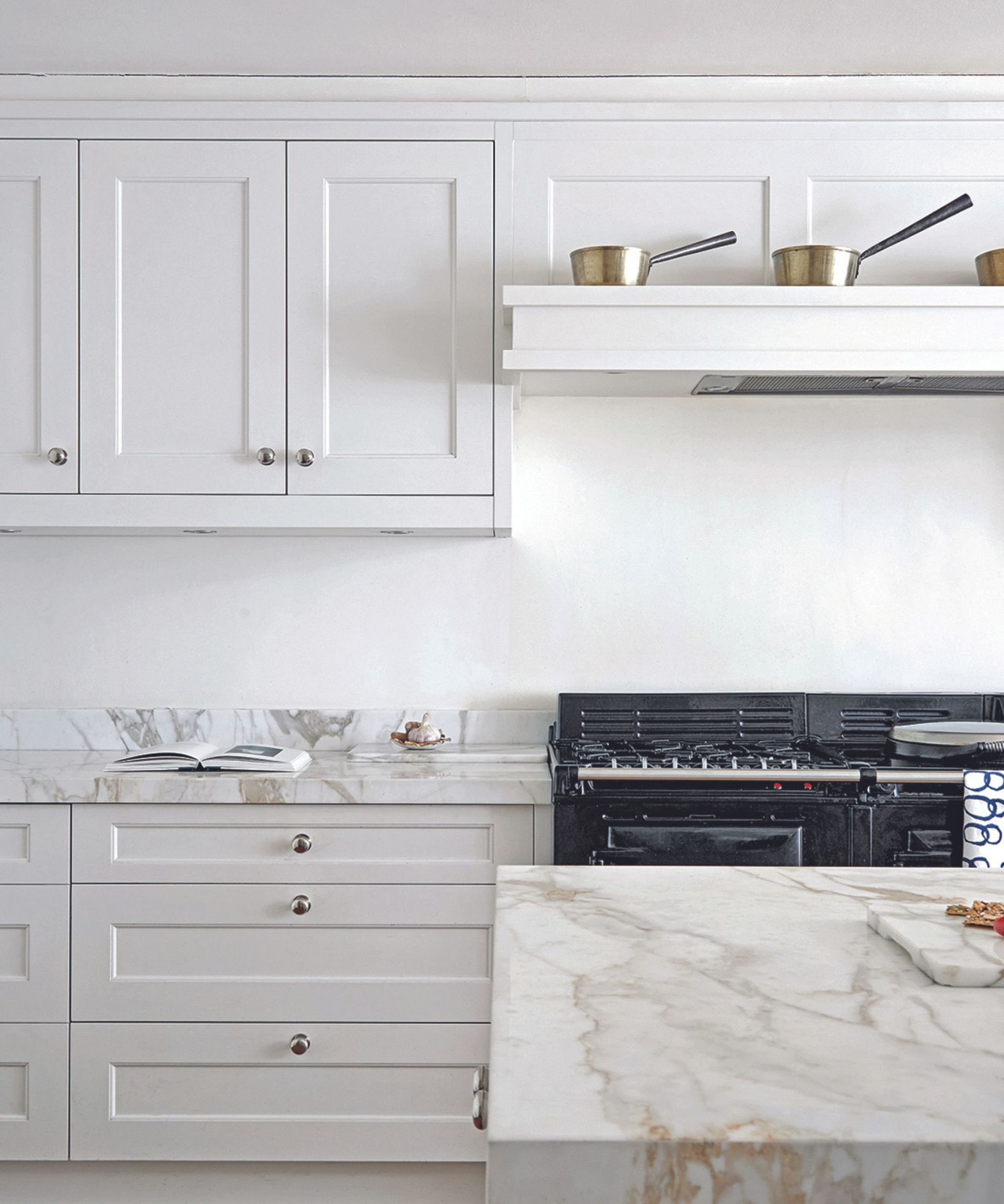 A white kitchen with marble countertops