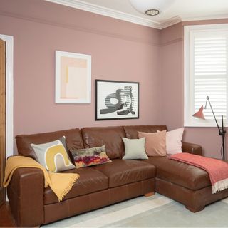 pink living room with leather sofa