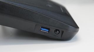 A USB 3.0 port lives on the left side of the device, around the corner from the front-mounted SD card reader. There's an eject button for safely removing storage devices from both.