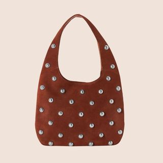 flat lay image of a brown suede handbag