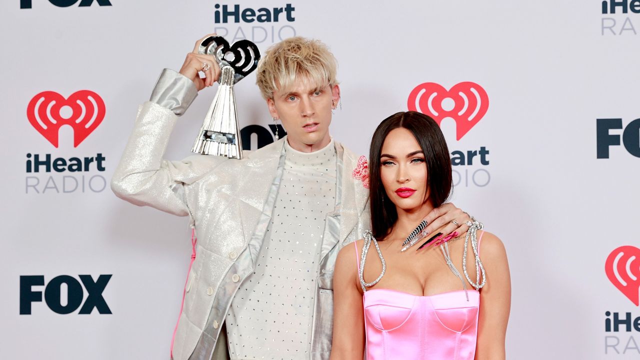 Machine Gun Kelly, winner of the Alternative Rock Album of the Year award for &#039;Tickets To My Downfall,’ and Megan Fox attend the 2021 iHeartRadio Music Awards